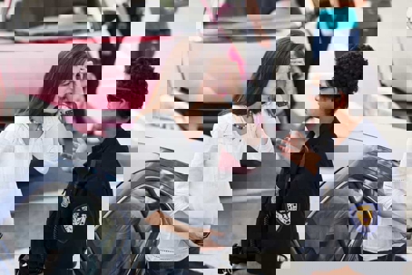 Woman Talking to Cop After Accident