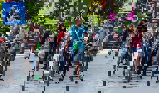 Young man rides an e-scooter through the city