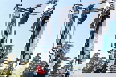 Close-up of the left side-view mirrors on a commercial truck