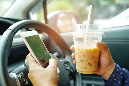 holding phone and coffee while driving