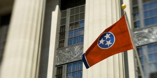 Picture of a red flag with 3 white star on the center