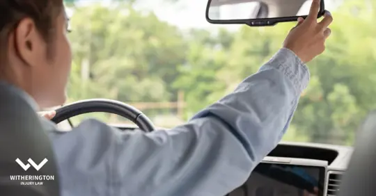 driver fixing rearview mirror